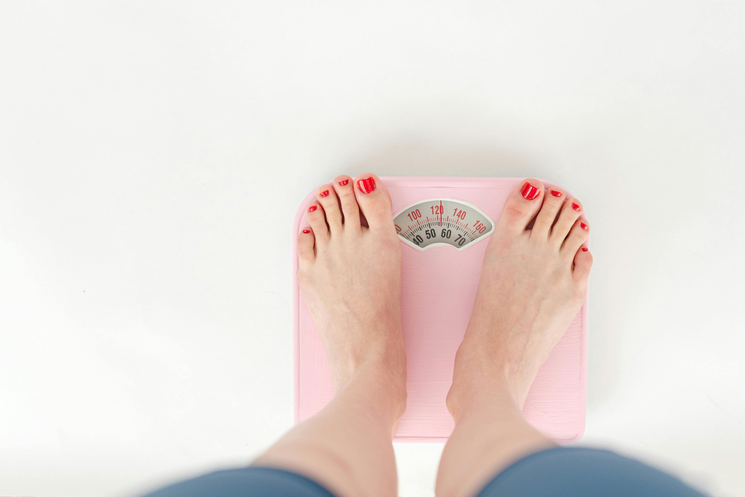 Woman stepping on scales